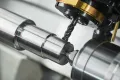 subtractive manufacturing concept - machining centre, turned parts, drilling.