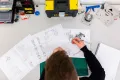 engineering apprentice looking at engineering drawings