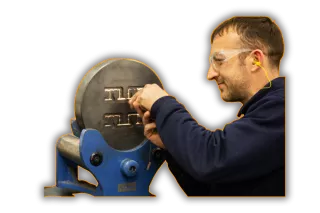 This is an image of man working on a aluminium extrusion, a service Qimtek supplier provide