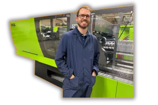 this is a man using an injection moulding machine- get moulding quotes from Qimtek moulding suppliers