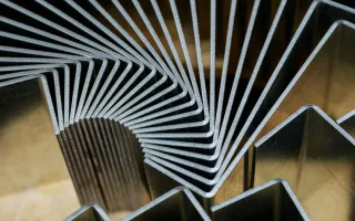 Stacked laser cut steel profiles showing clean edges and consistent thickness, highlighting precision laser cutting quality and repeatability in metal laser cutt