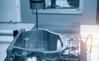 Touch-probe measuring head inspecting a precision-machined metal housing on a CNC machine bed, highlighting quality control and dimensional inspection.