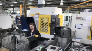 Media Name: machine_operator_running_cell_of_two_fanuc_machines.jpg