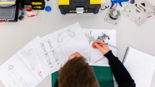 engineering apprentice looking at engineering drawings