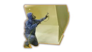 This is an image a man spray painting a tractor - a typical service provided by Qimtek members