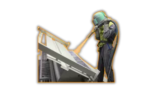 This is an image of a person shot blasting a still fabrication - a typical service Qimtek supplier provide.
